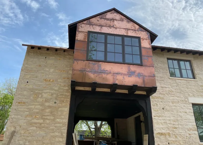 Copper metal panel facade on a stone building for Skylight Installation in Grand Ledge