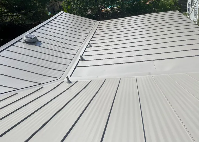 Solar attic fan installed on a metal roof for Roof Ventilation in Grand Ledge
